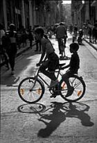 Kids riding on a bike in Havana.
